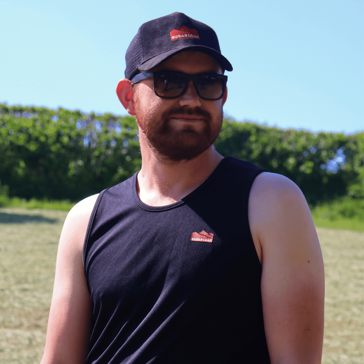 Black farming vest built for summer shearing and farm wear, shown on model outdoors.