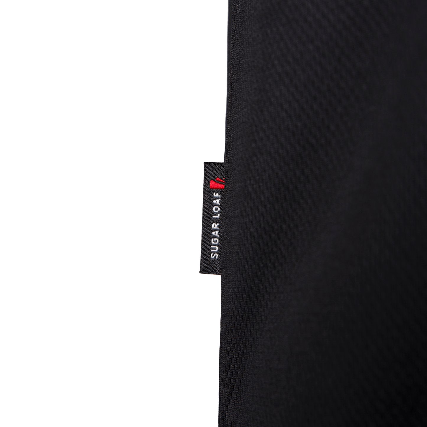 Close-up of branded side tab on Sugar Loaf shearing vest - high-quality shearing clothing and farming vest design.