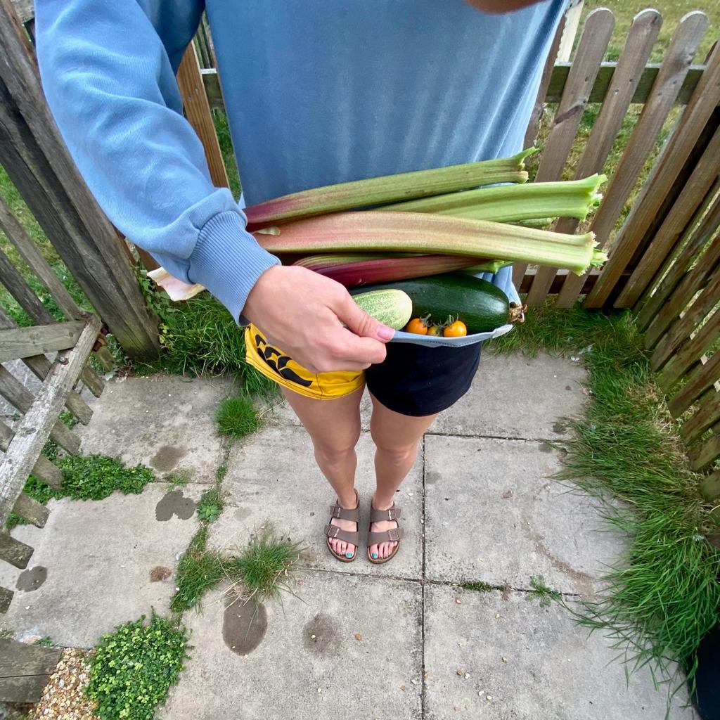 Man wearing Canterbury clothing for farmers and showing off fresh produce