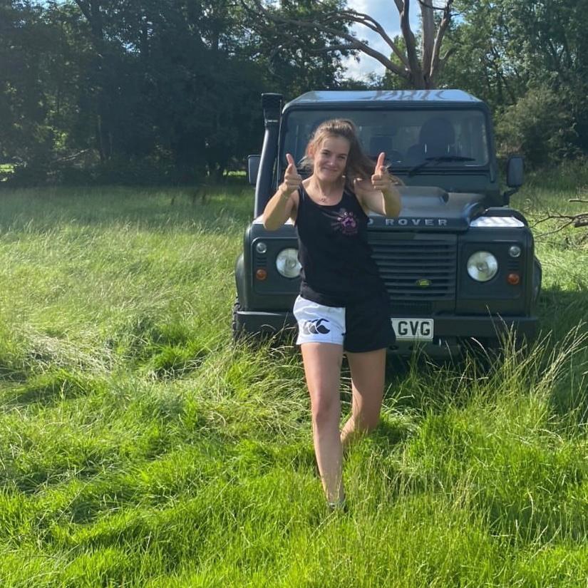 Range Rover driver wearing Canterbury rugby clothing and pointing at the camera
