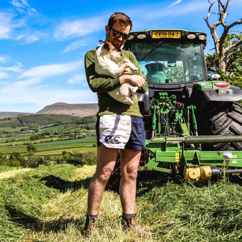 Man wearing the Canterbury Clothing New Zealand range and holding a dog