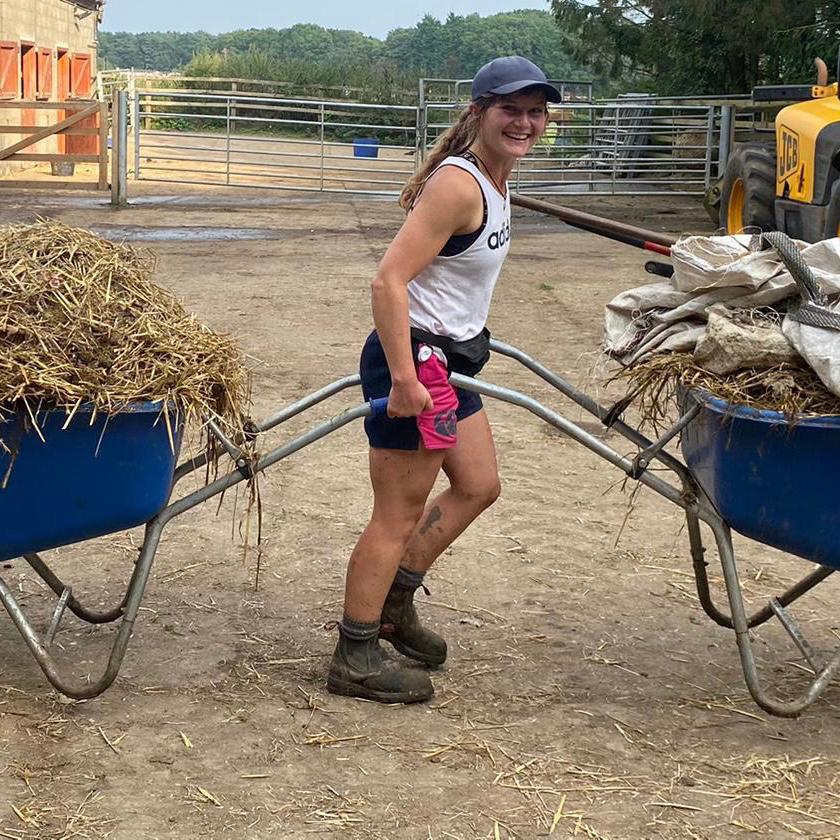 Pink and navy canterbury shorts worn by worker pulling a wheelbarrow