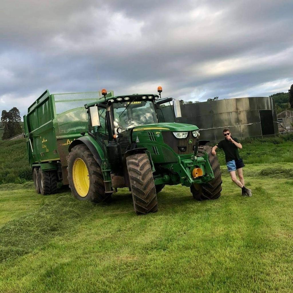 Man posing next to harvest vehicle wearing Canterbury harlequin shorts