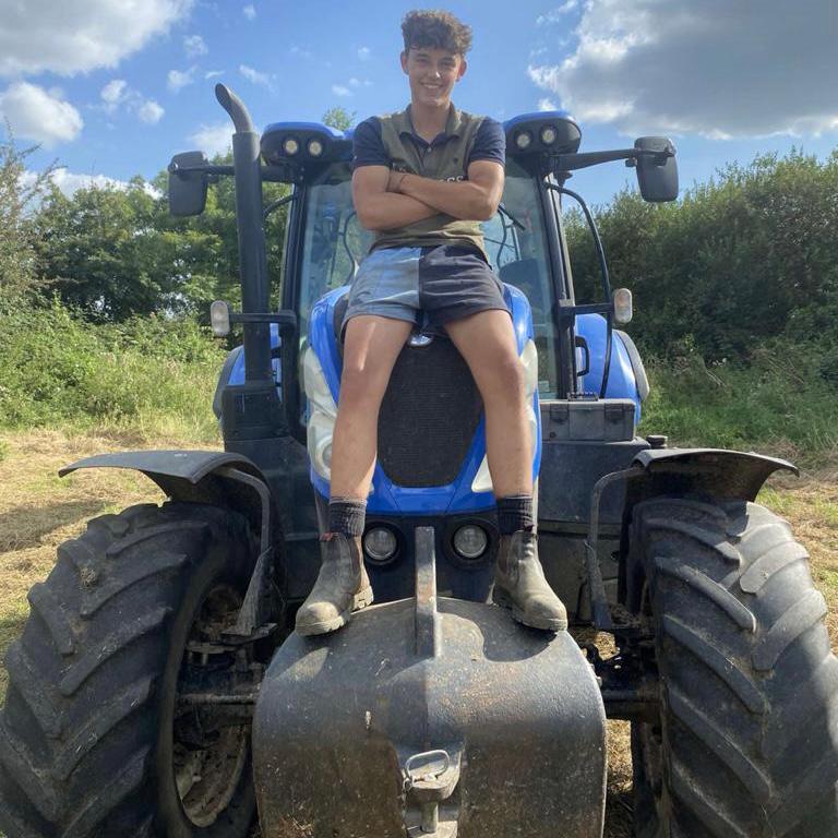 
                  
                    Young farmer wearing cronulla navy canterbury shorts and sitting on a tractor
                  
                