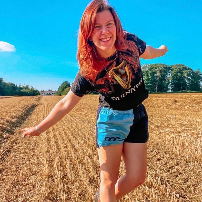 Woman wearing Canterbury clothing UK and running around a field