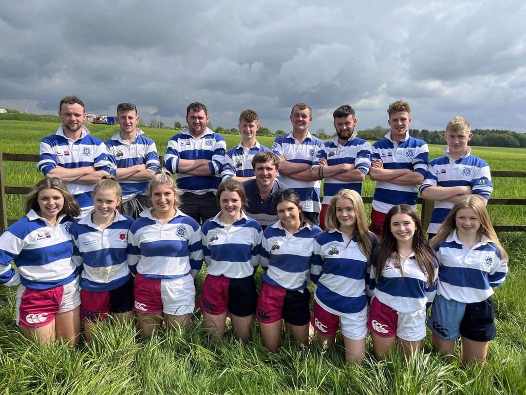 A team of rugby players wearing Canterbury harlequin shorts and posing for the camera