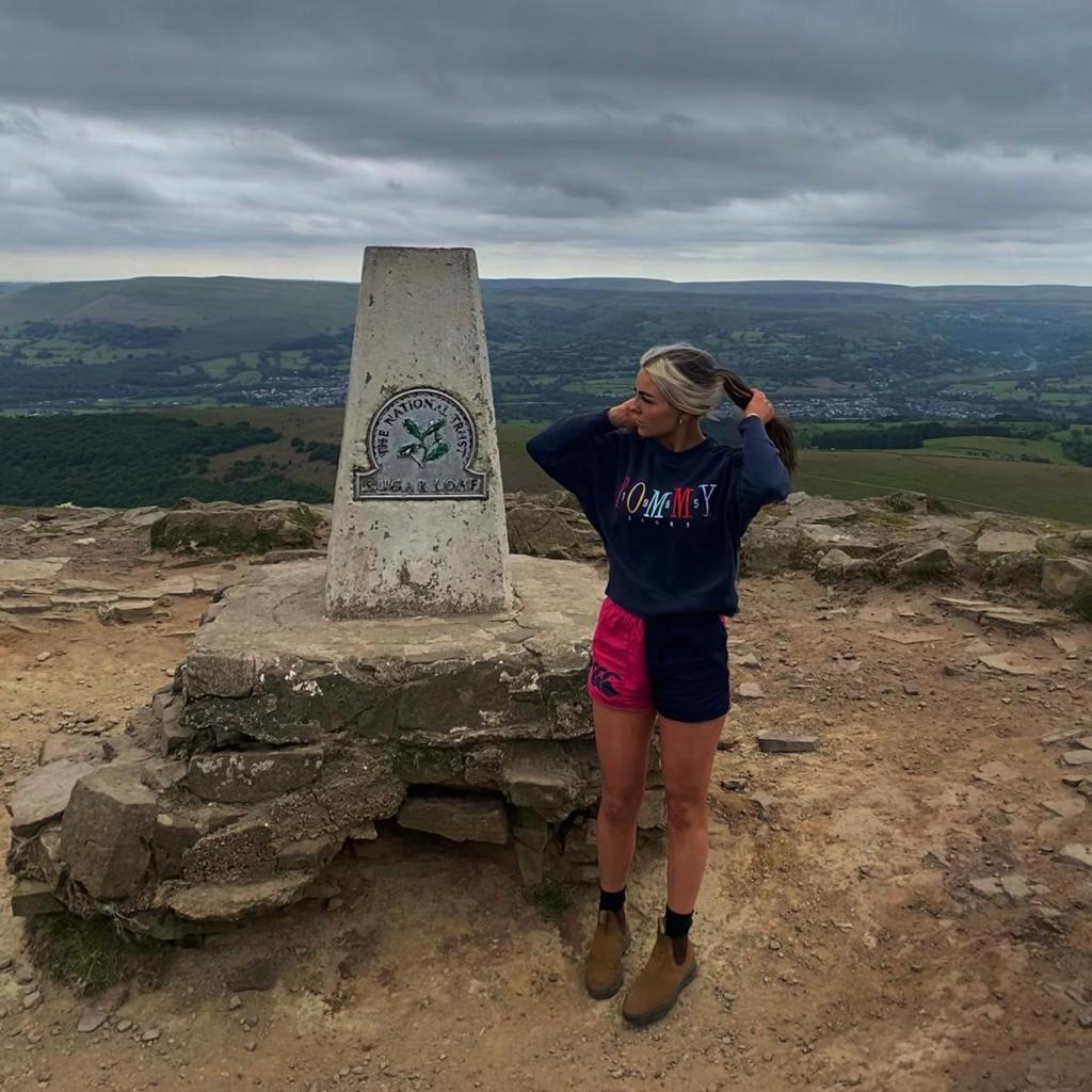 Woman wearing Canterbury harlequin shorts standing next to a landmark