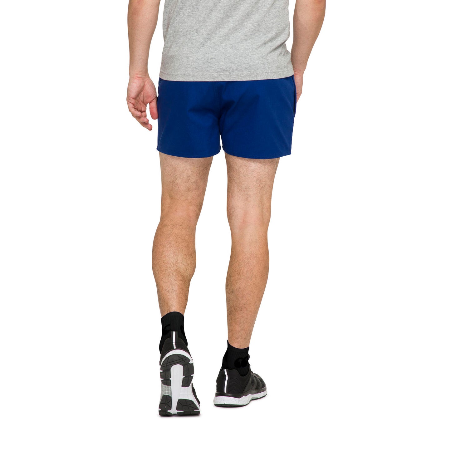 Rear view of model wearing royal blue Canterbury rugby clothing