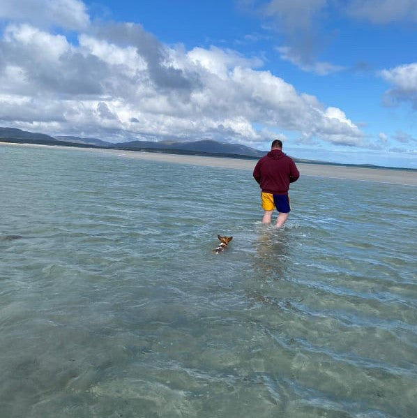 Man wearing Canterbury rugby clothing walking in the ocean