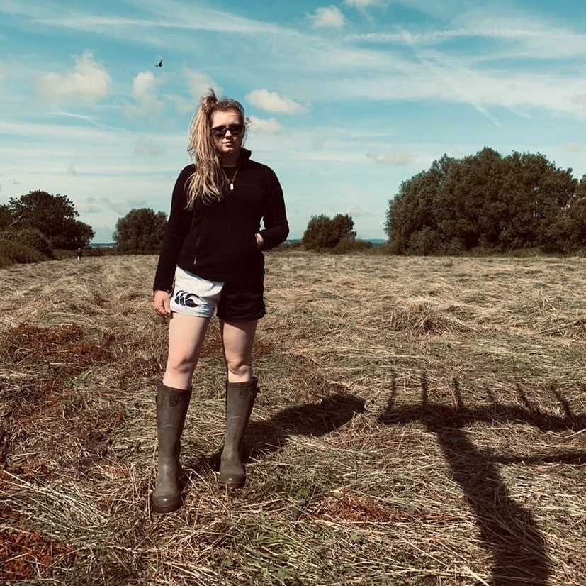 Woman wearing Canterbury harlequin shorts and wellington boots