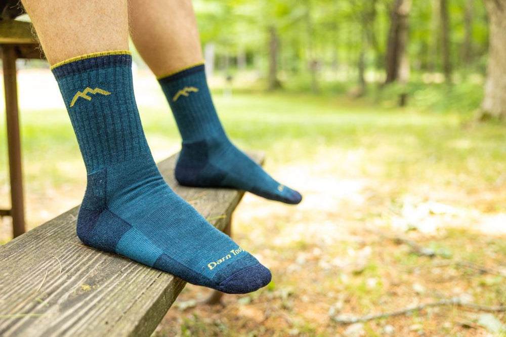 Man wearing darn tough merino wool socks UK teal coloured socks