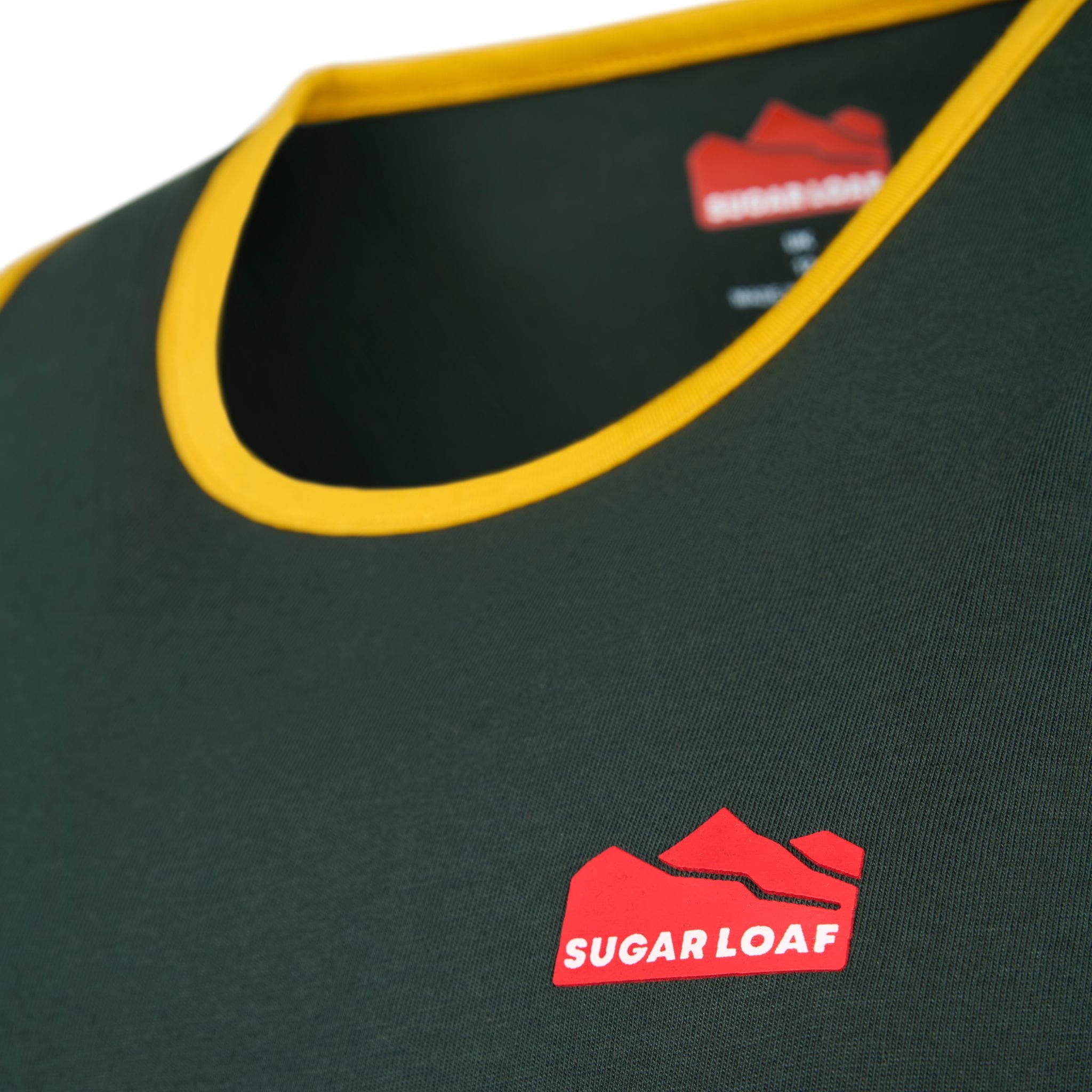 
                    
                      Sugar Loaf branding and neckline detail on Green and Gold kids long tail singlet.
                    
                  