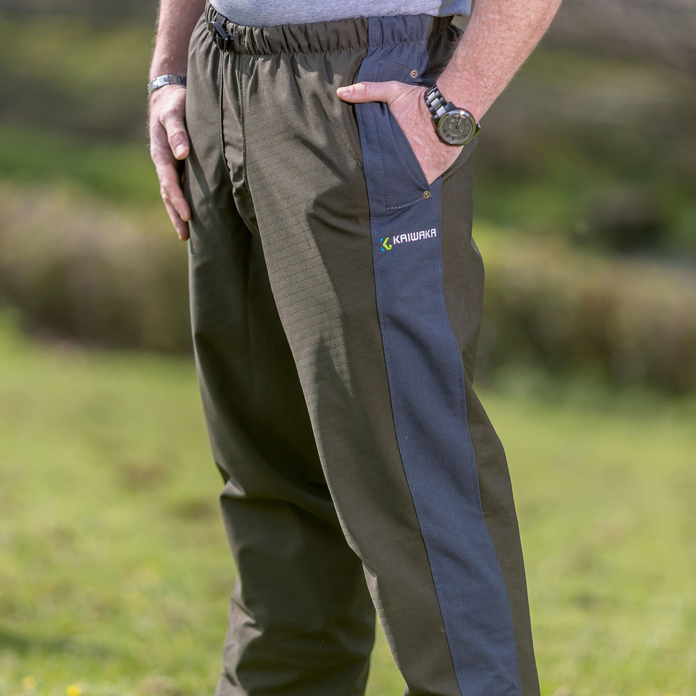 
                  
                    Lifestyle shot of Kaiwaka waterproof trousers, part of Kaiwaka clothing’s agricultural workwear range.
                  
                