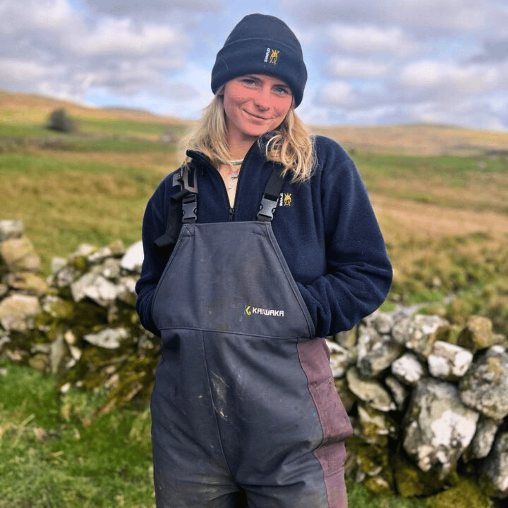 
                  
                    Farmer wearing Kaiwaka Women’s Stormforce Bib and Brace, a durable waterproof bib and brace for farming.
                  
                