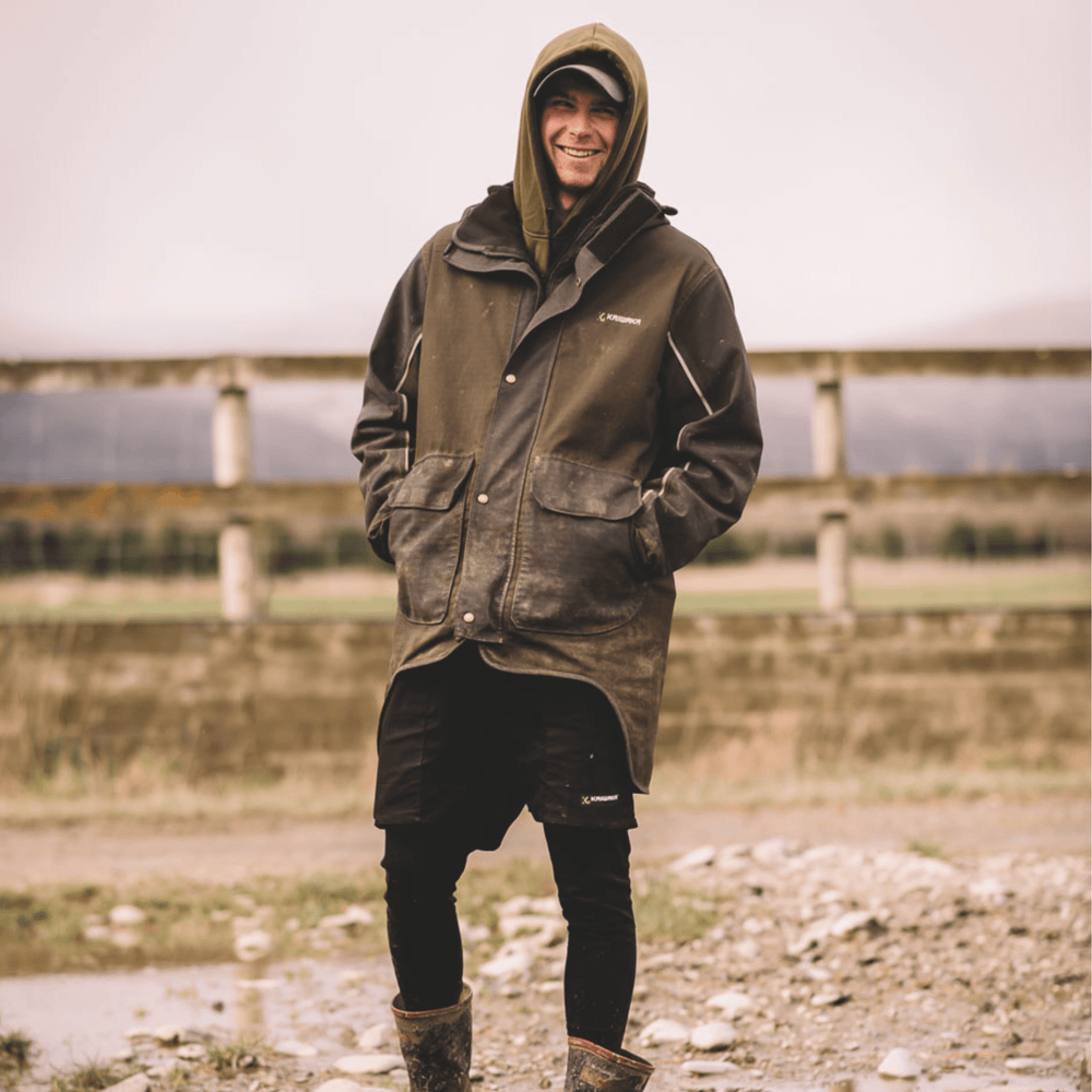 Farmer wearing Kaiwaka Men's Stormforce Winter Jacket, a waterproof farm jacket from Kaiwaka clothing.