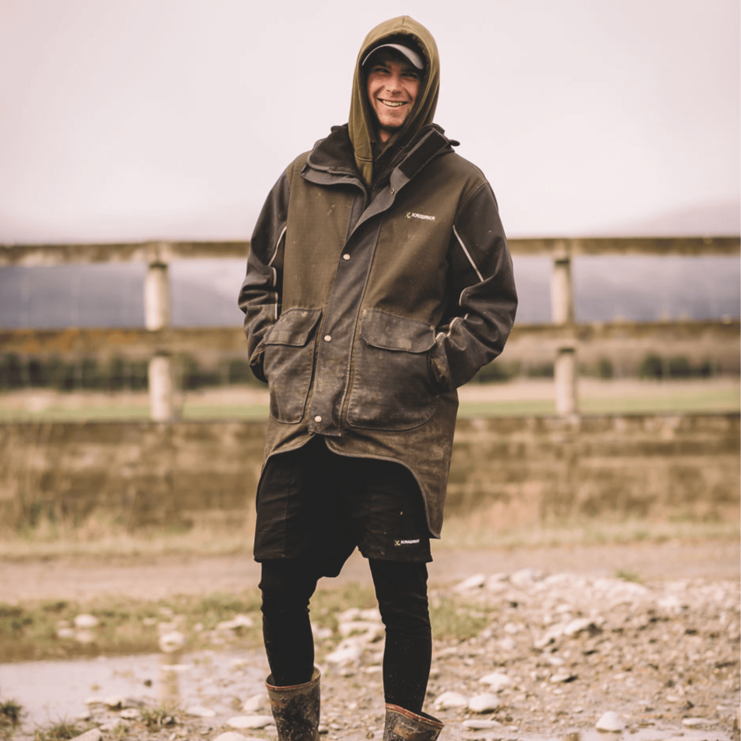 Farmer wearing Kaiwaka Men's Stormforce Winter Jacket, a waterproof farm jacket from Kaiwaka clothing.