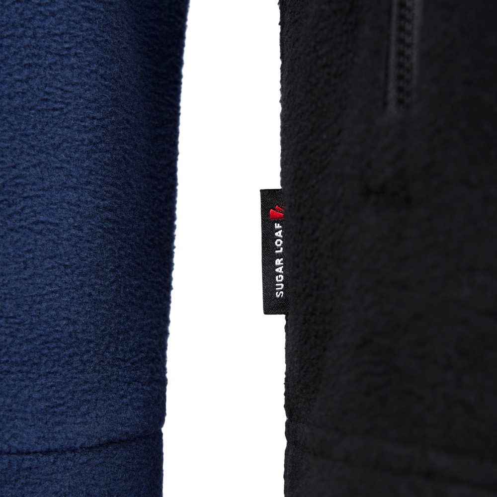 
                  
                    Close-up of fleece fabric texture and brand tag on navy Dawnbreaker fleece, heavy-duty farming hoodie.
                  
                