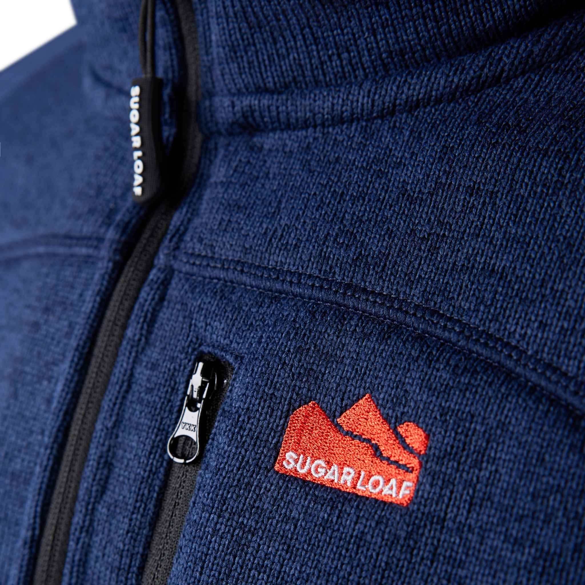 
                    
                      Close-up of embroidered Sugar Loaf logo on the Sugar Loaf navy work fleece.
                    
                  