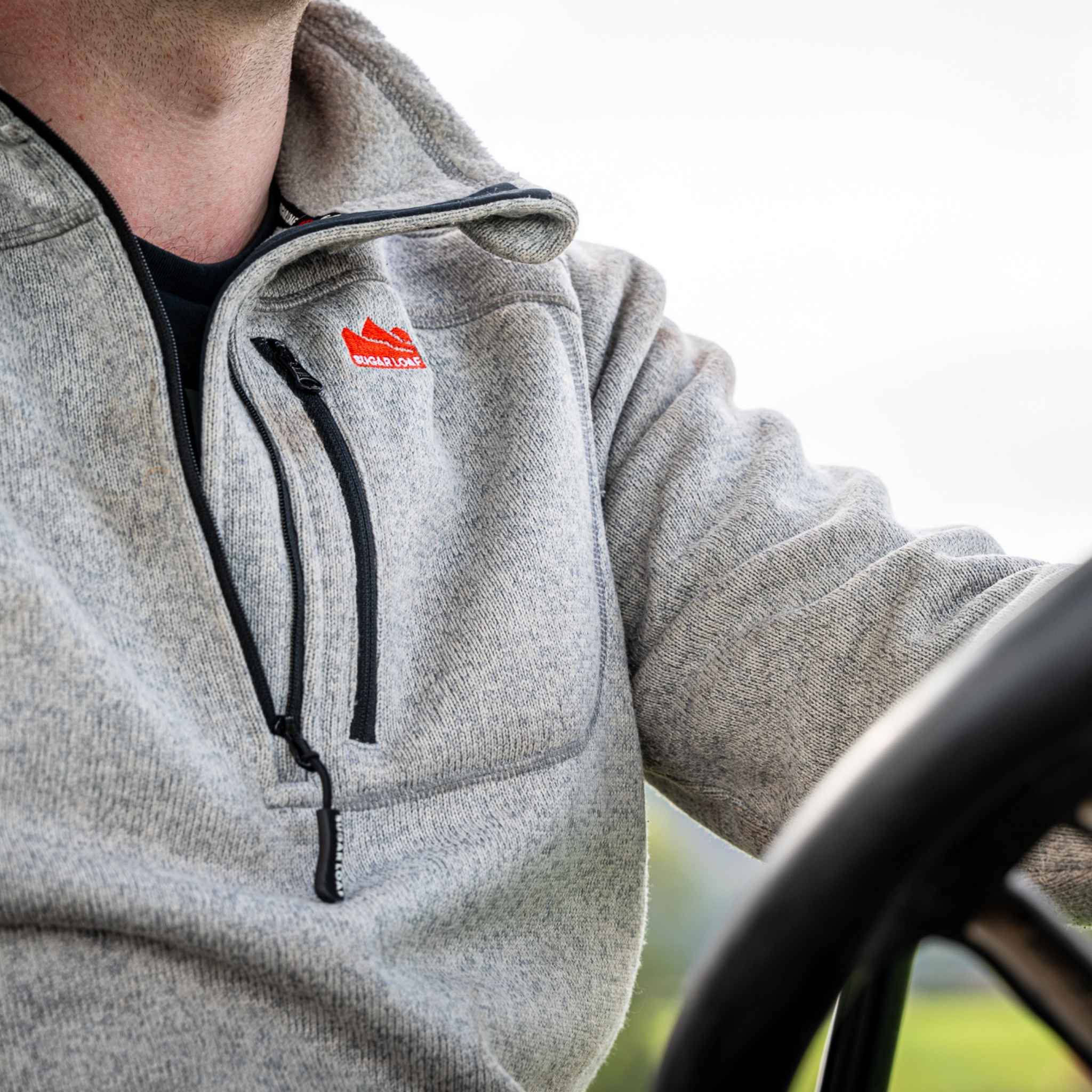 
                    
                      Close-up chest detail of the Sugar Loaf Fell Half Zip Fleece ash worn on the farm, practical farming fleece.
                    
                  