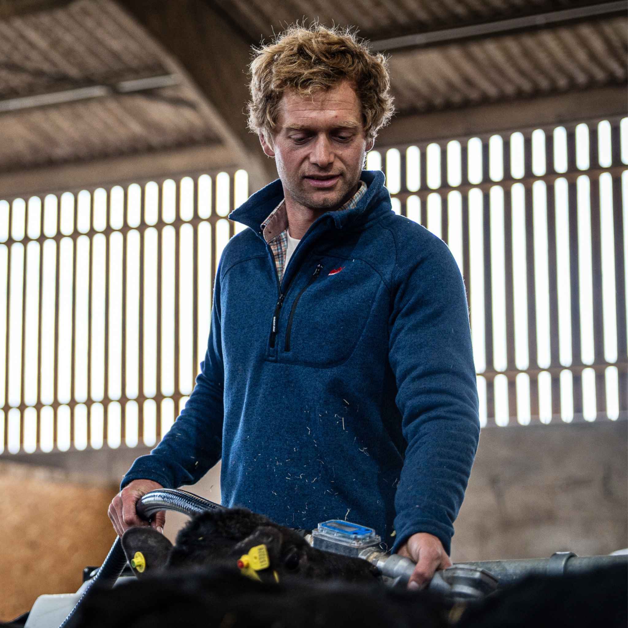 
                    
                      Male farmer outdoors in Sugar Loaf Fell Half Zip Fleece navy, durable agricultural clothing
                    
                  