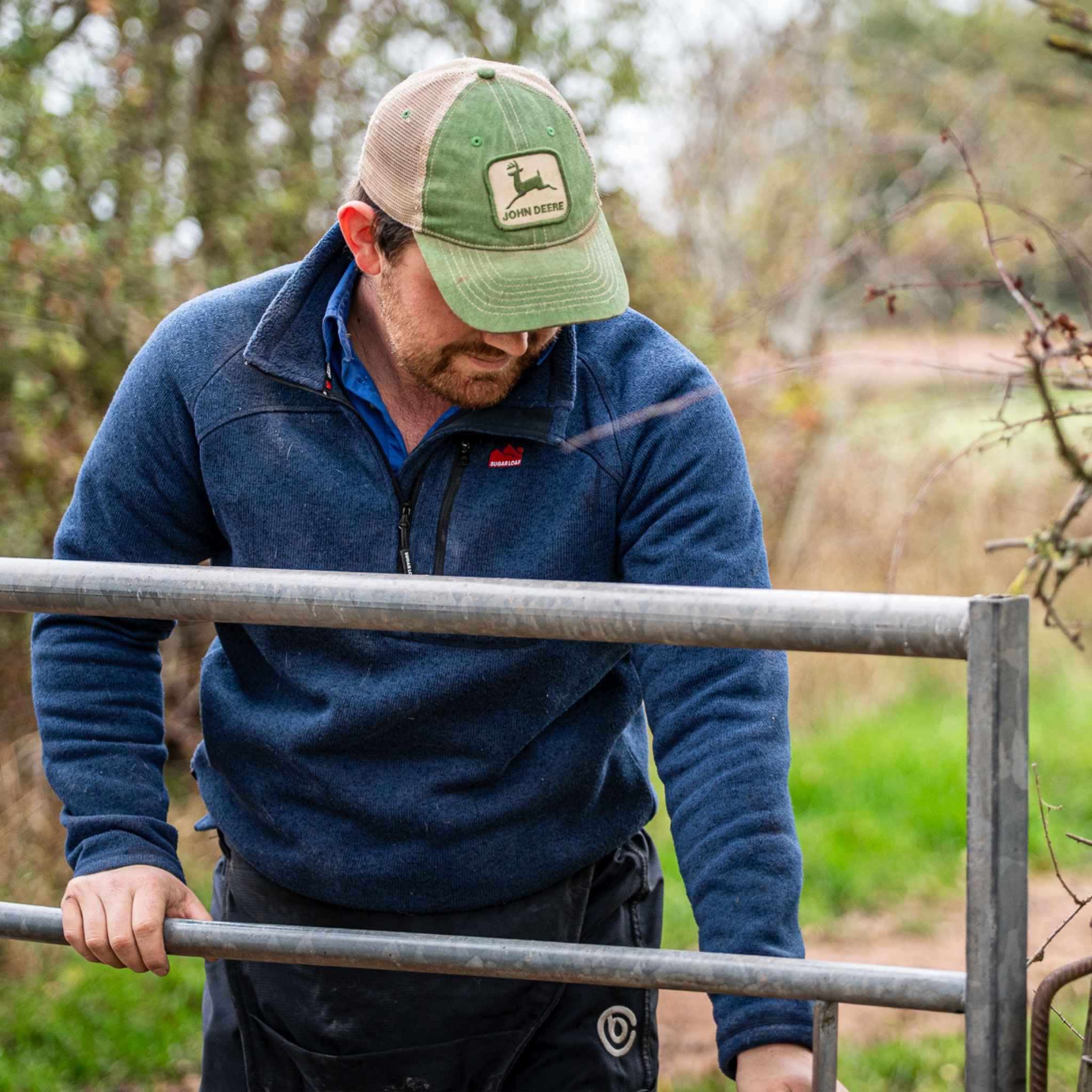 
                    
                      Farmer in the field wearing Sugar Loaf Fell Half Zip Fleece, practical farming fleece built for tough conditions.
                    
                  