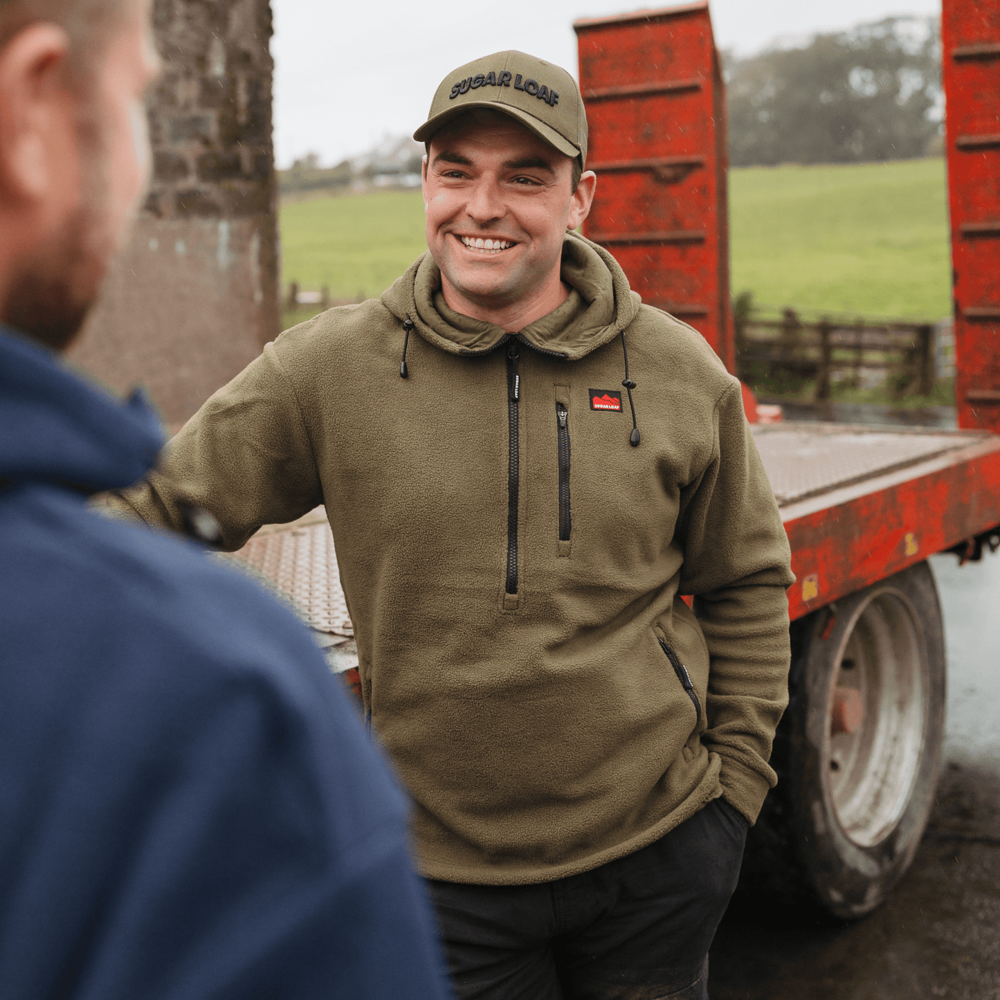 Farmer wearing the Sugar Loaf Shepherd Polar Fleece Farming Hoodie in Khaki.