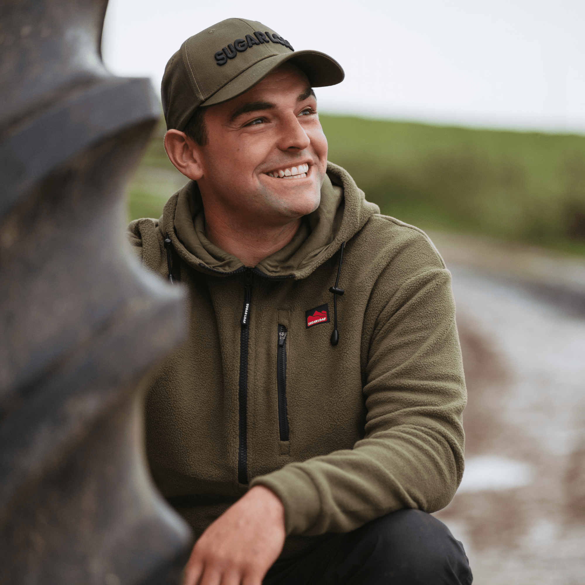 Male farmer in the Khaki Sugar Loaf Shepherd Hoodie - a warm and versatile men's country fleece.