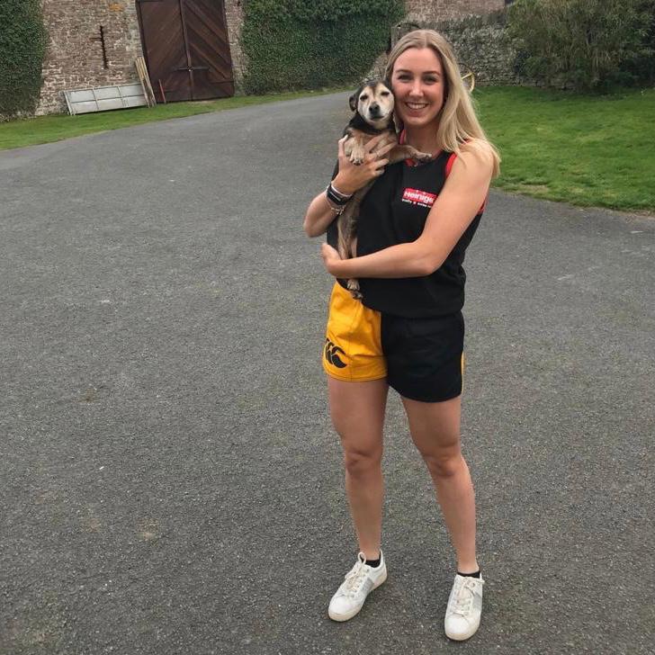 
                  
                    Woman wearing rugby shorts with pockets and holding her dog
                  
                