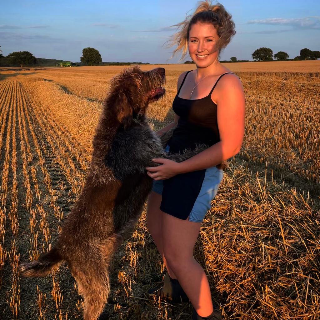 
                  
                    A woman wearing canterbury clothing UK shorts and hugging her dog
                  
                