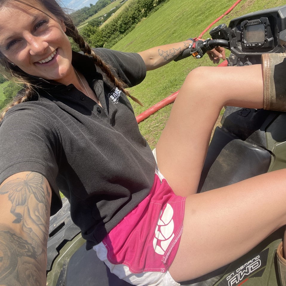 
                  
                    Woman taking a selfie of wearing pink and white Canterbury shorts on a quad bike
                  
                