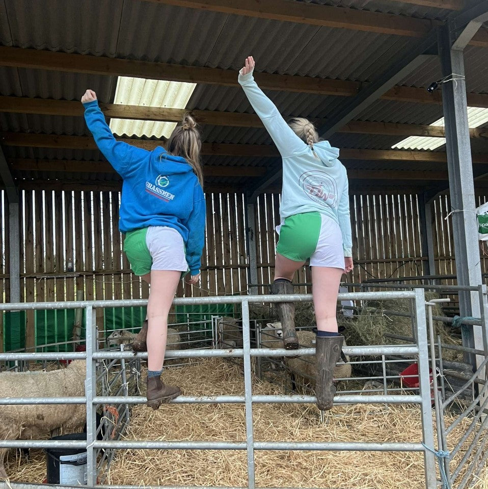 
                  
                    Two women wearing Canterbury rugby shorts with pockets and standing on a fence
                  
                