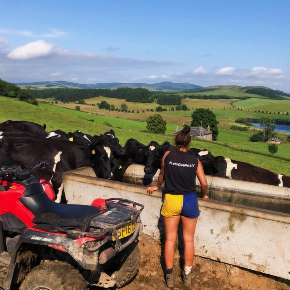 
                  
                    Dairy farmer wearing Canterbury rugby clothing and feeding cows
                  
                