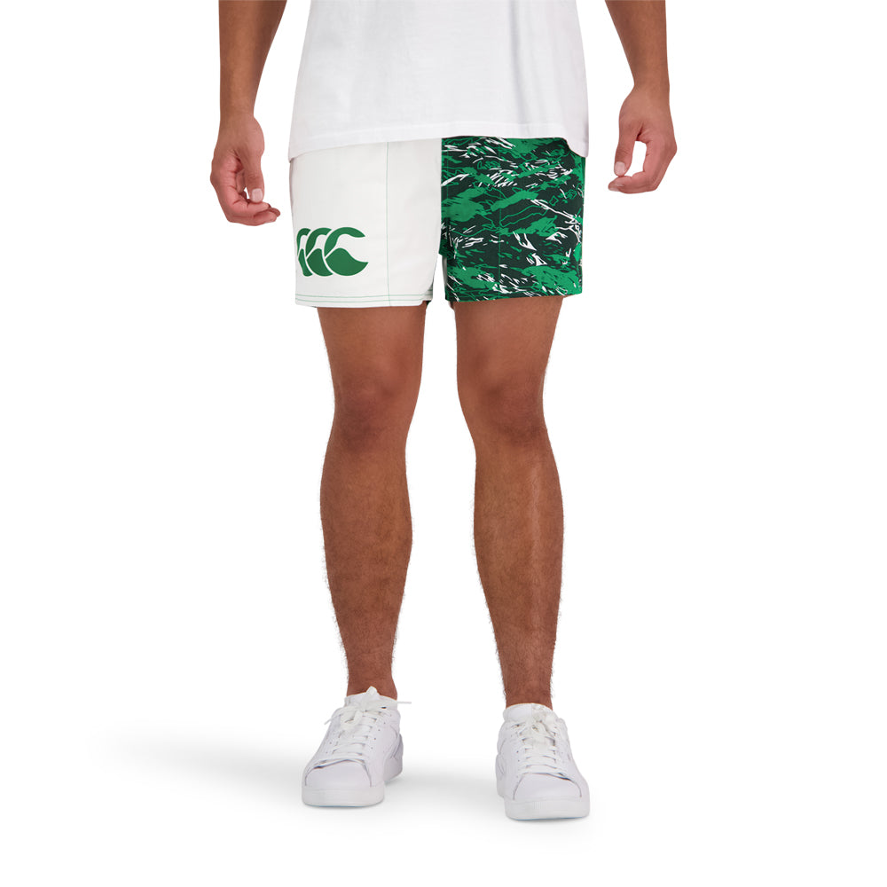 Man in white shirt and a pair of militia and green Canterbury shorts