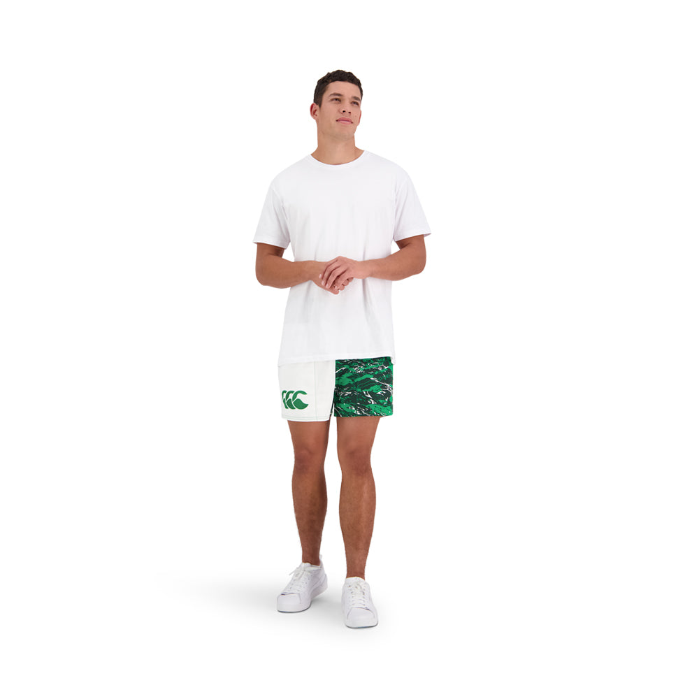
                  
                    Model wearing white and green Canterbury rugby clothing
                  
                